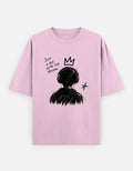 Pink oversized t-shirt with a hand-drawn child graphic, crown, star and "Just a kid with big dreams" text