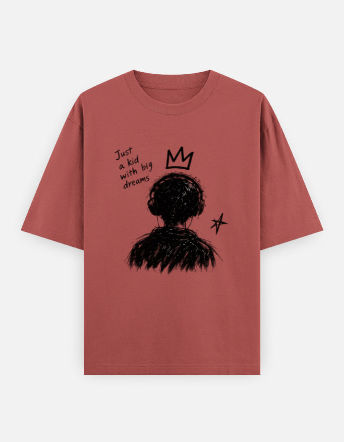 Red oversized t-shirt with a hand-drawn kid with big dreams graphic, crown and star on the front